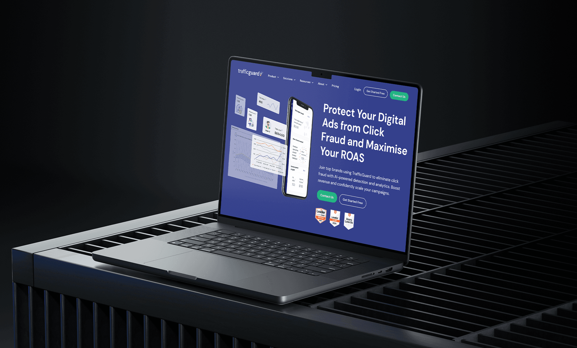 Laptop on dark surface showing TrafficGuard digital ad fraud protection site