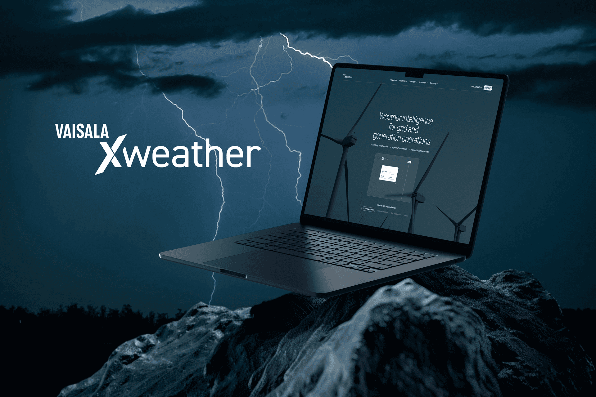 Laptop showing Vaisala Xweather wind energy dashboard against a stormy sky with lightning and wind turbines