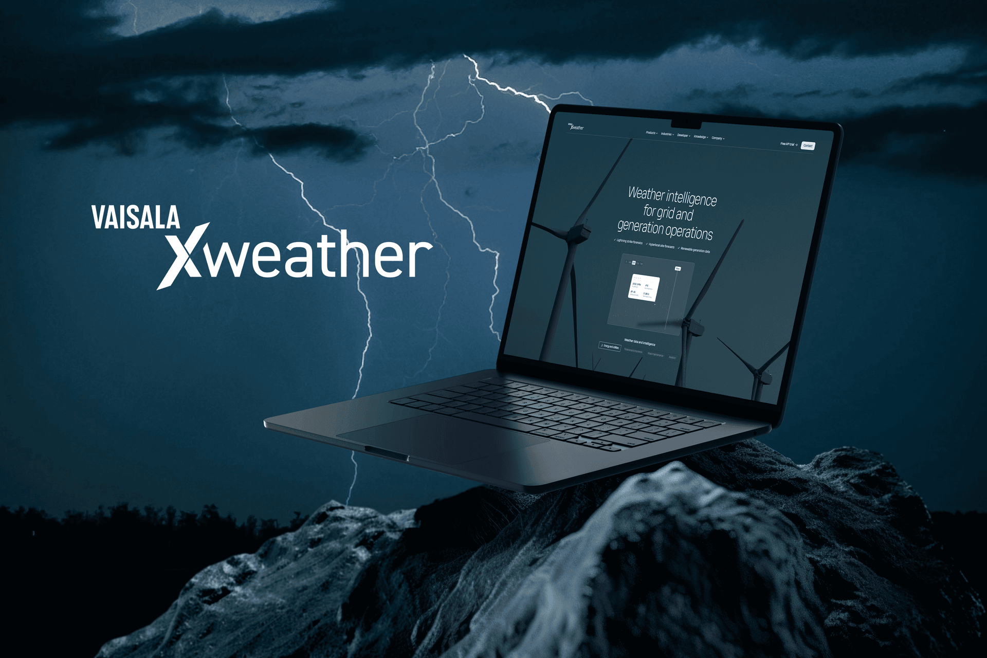 Laptop showing Vaisala Xweather wind energy dashboard against a stormy sky with lightning and wind turbines