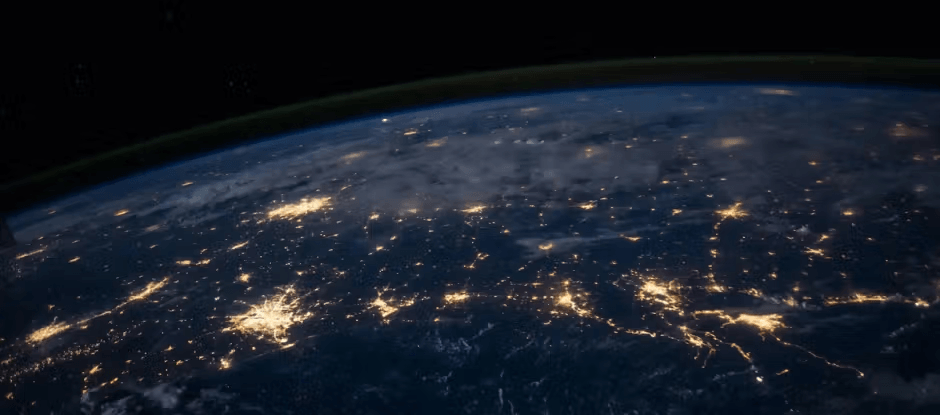 Earth at night from space showing city lights across continents