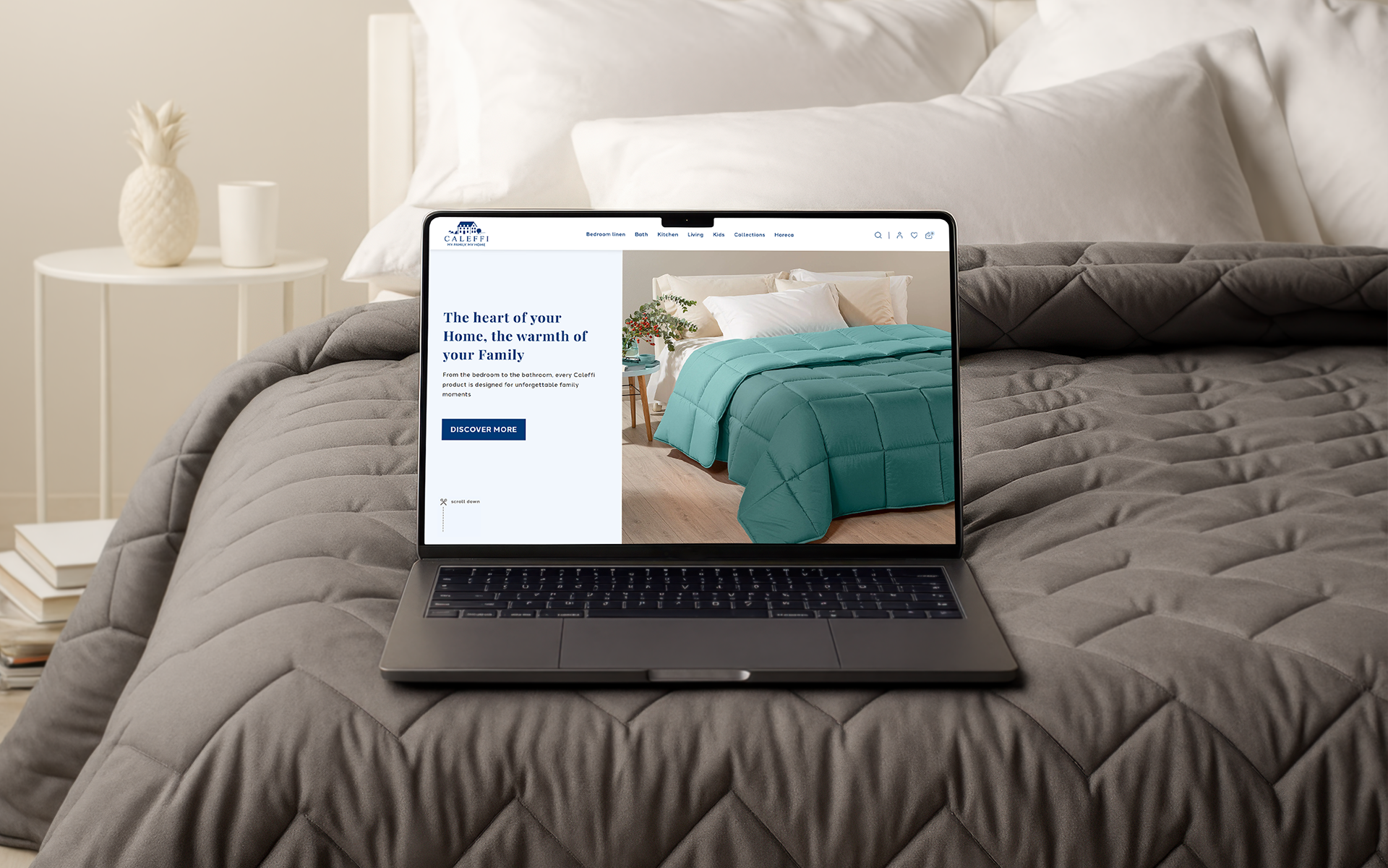 Laptop on bed showing Caleffi home textiles e-commerce website